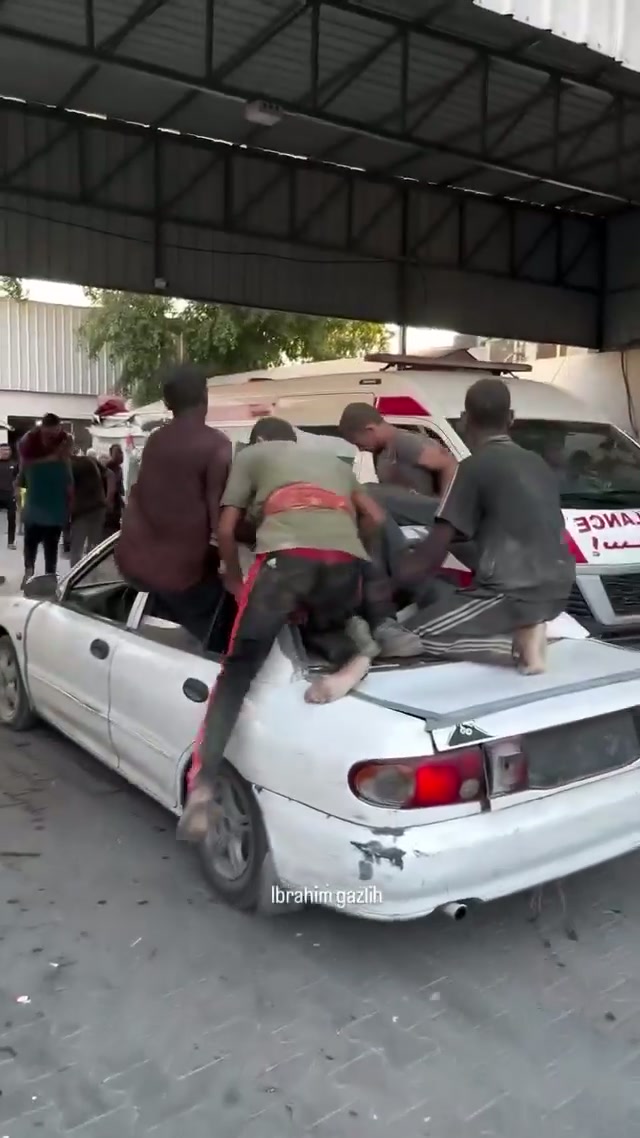 Boys clinging to car near ambulances